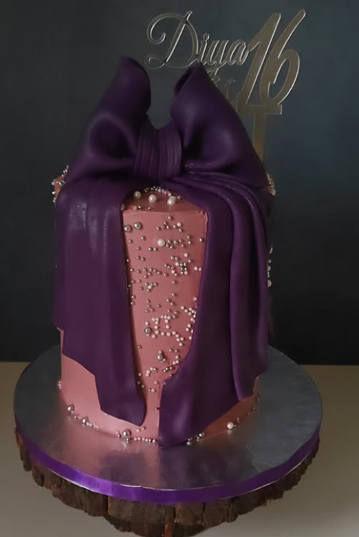 Elegant purple satin bow celebration cake with pearl details - Vivante Patisserie Bangalore